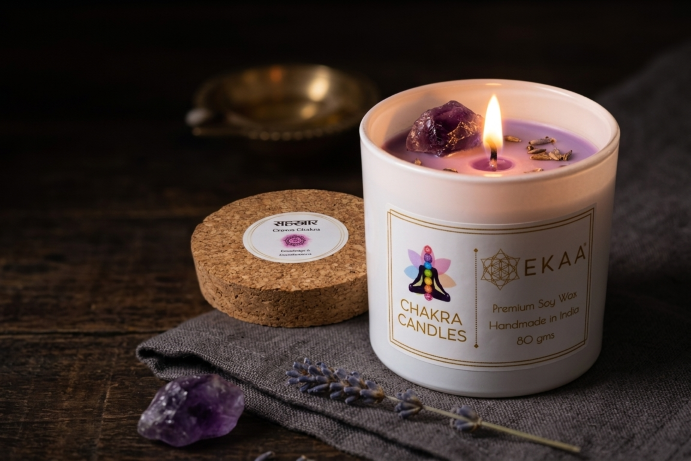 EKAA amethyst crystal candle in organic soy wax with a real amethyst stone and dried lavender, lit, made in India